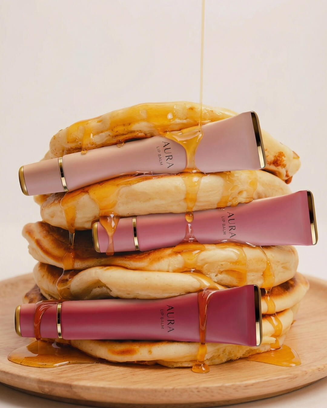 Untitled Commercial cosmetic product photography concept for a lip balm brand, contrasting with a stack of honey-dripping pancakes.