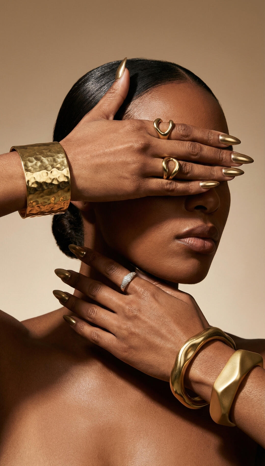 Macro jewelry and accessory brand photography concept, highlighting reflective gold bracelets, rings, and metallic gold nail art.